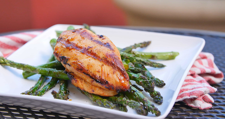 Grilled tequila lime chicken over grilled asparagus