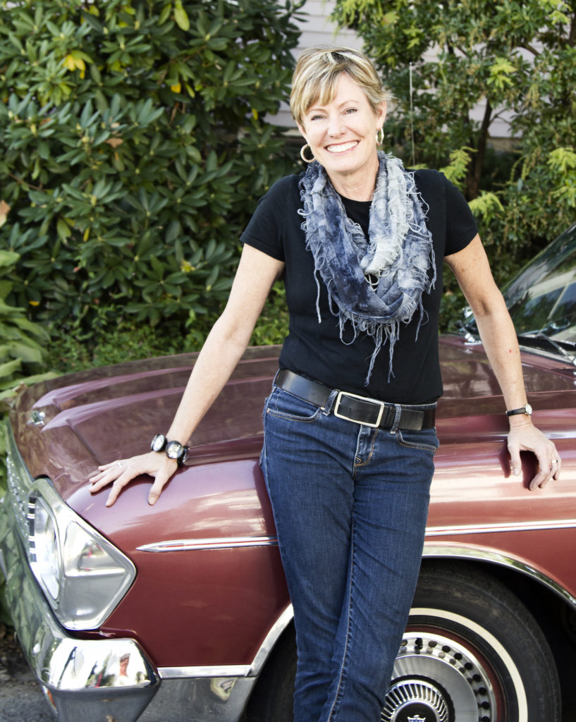 The Grommet's Jules Pieri leaning on a vintage maroon car.