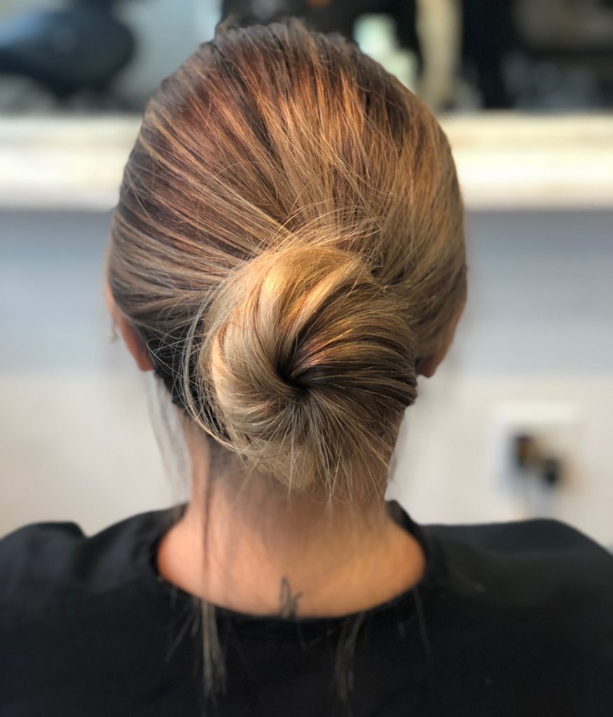 Low dirty blonde bun from the back