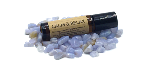 Seeking Om Calm & Relax roll-on essential oil bottle on pile or lavender crystals