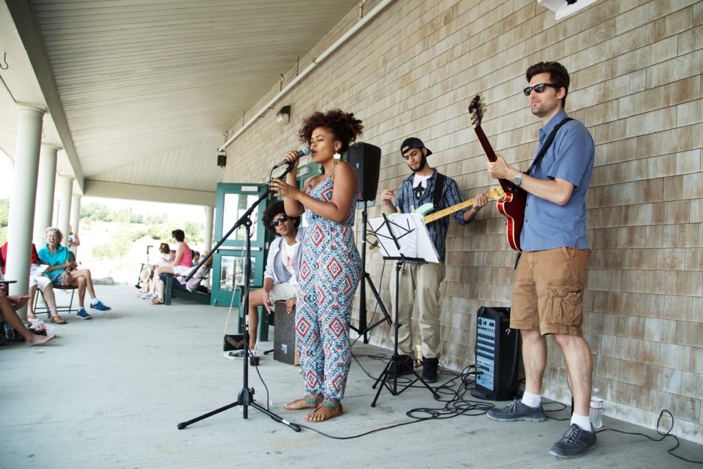 band performing in front of tan shingled wall at Jazz on the Porch on Spectacle Island 