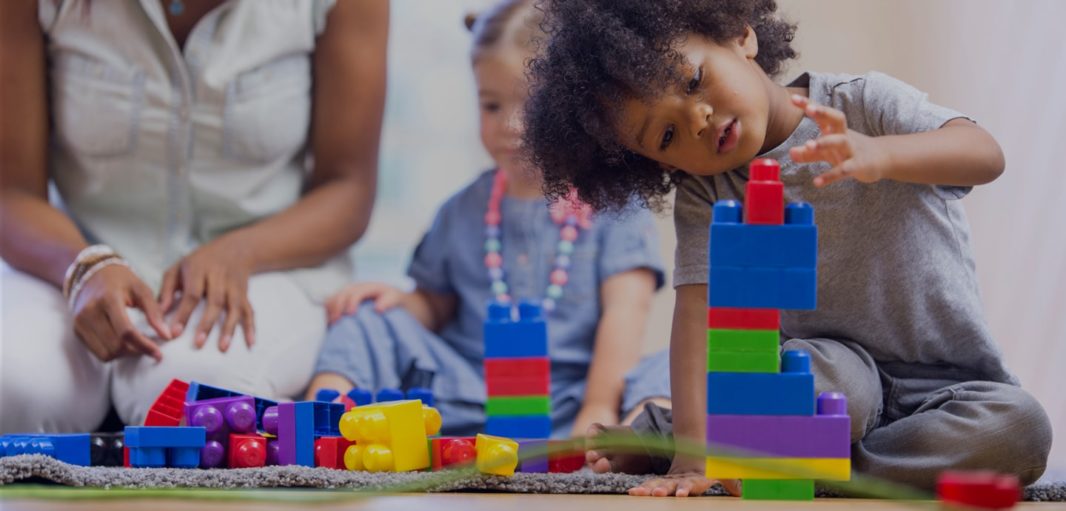 Kids playing with colorful building blocks