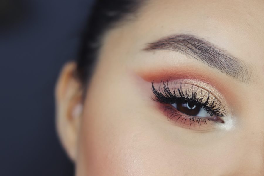 Closeup of a perfectly arched eyebrow and dark lashes