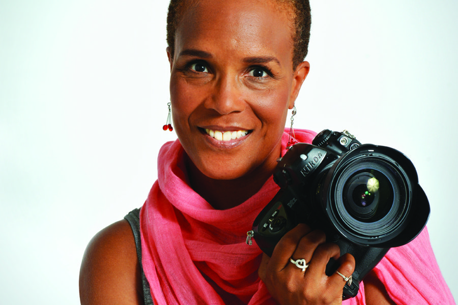 Filmmaker Tracy Heather Strain in pink scarf with her camera