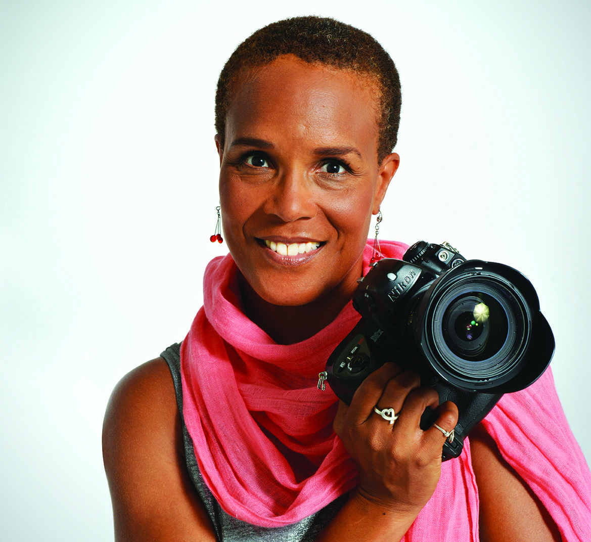 Filmmaker Tracy Heather Strain in pink scarf with her camera