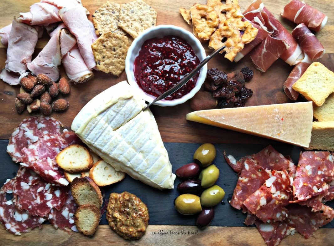 Bantam Cider’s Big Cheese & Charcuterie Party platter with assorted cured meats, cheeses, olives, and crackers photographed from above