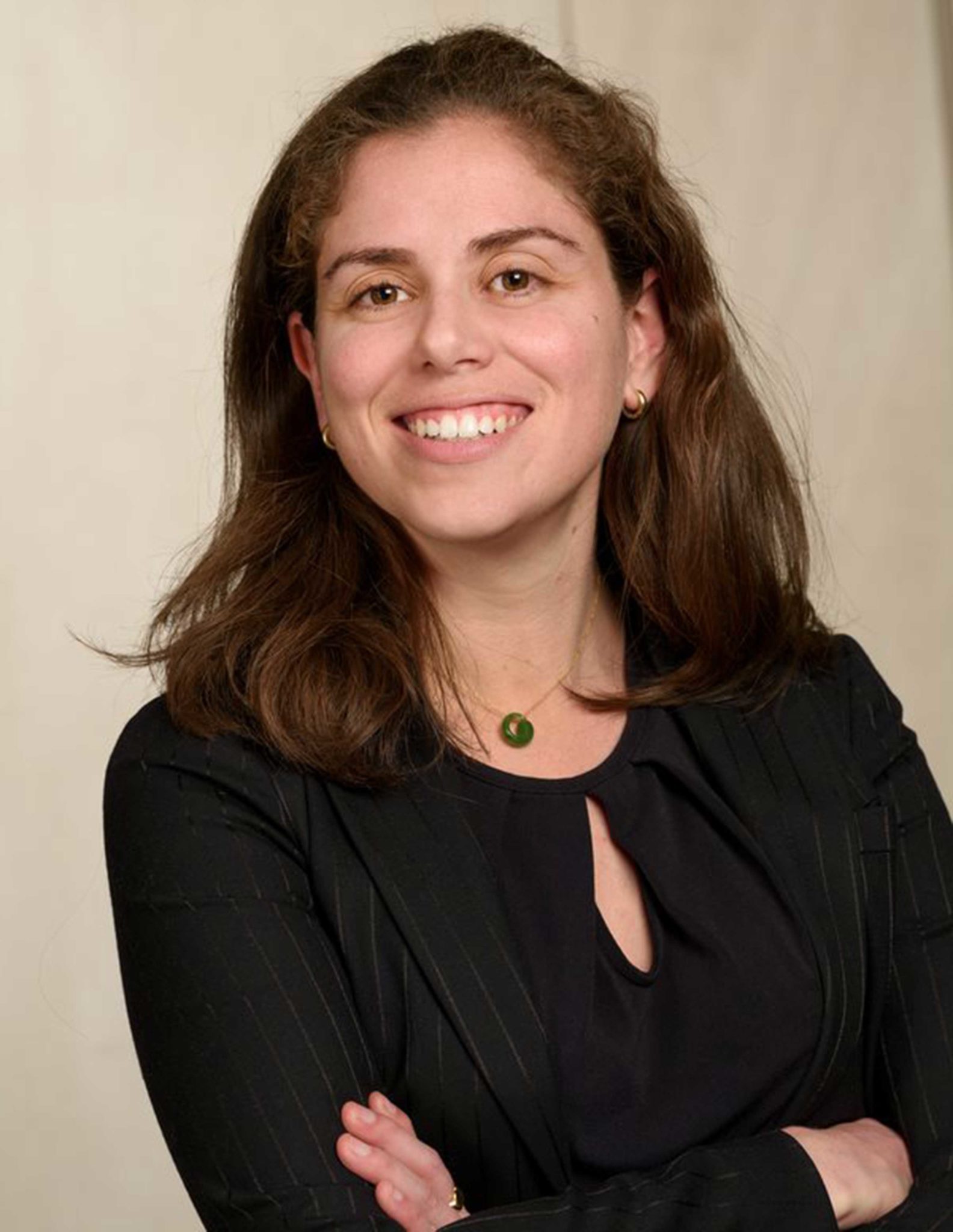 Three-quarter photo of Dr. Chana Sacks in black top with arms crossed 