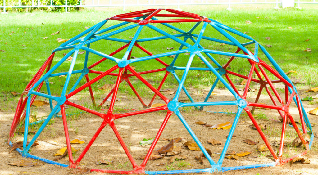 Red and teal iron dome in a playground