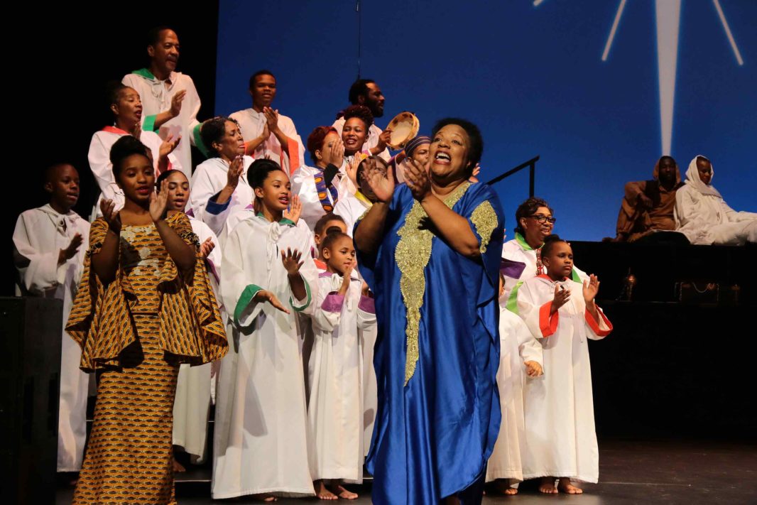 Mildred E. Walker Washington and Ashley Villard lead the "Black Nativity" cast in singing "Joy to the World." 