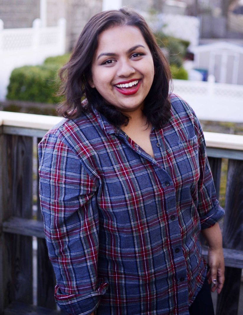 Comedian Isha Patnaik in a plaid flannel shirt