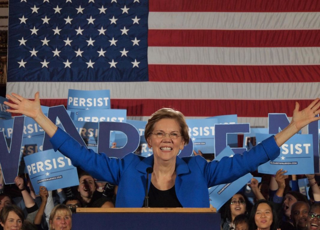 Senator Elizabeth Warren in front of American flag at midterm election night party