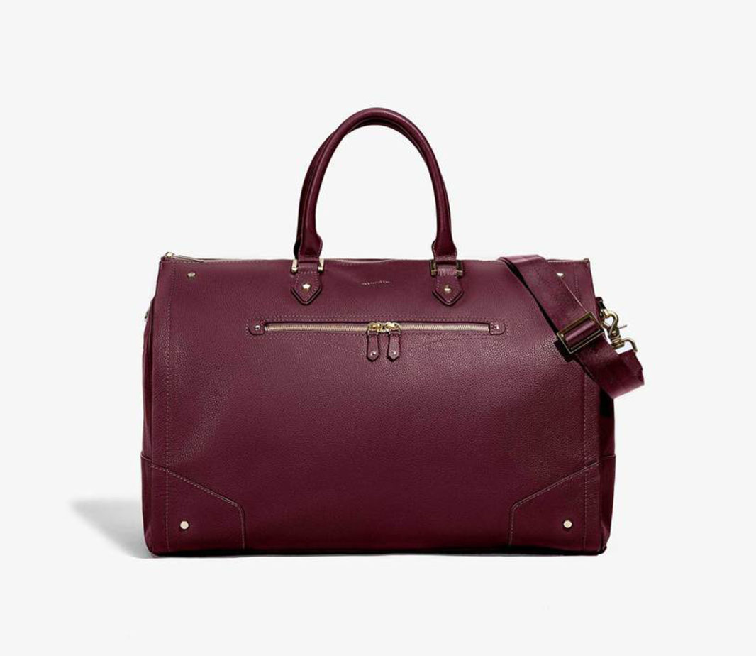 Hook + Albert Garment Weekender Leather Carry-On Duffle bag with golds front zip pocket in Bordeaux. Rolled top handles and shoulder strap.