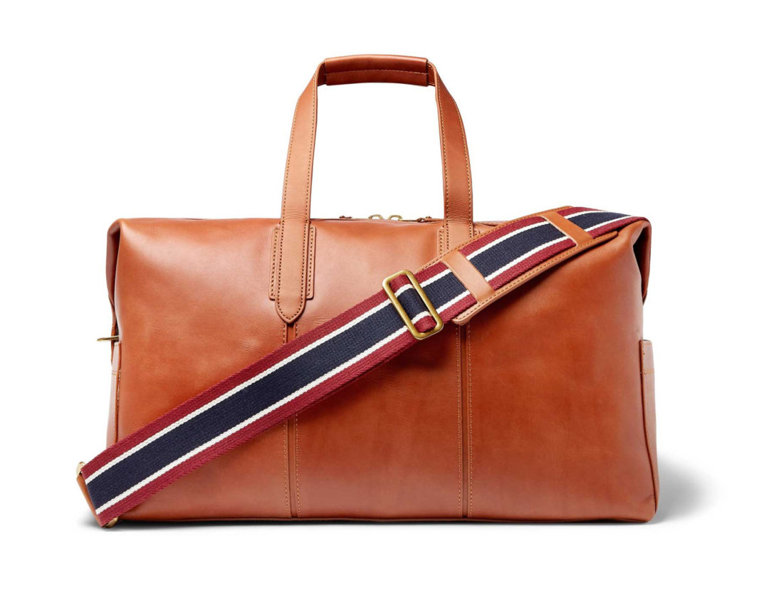 J.Crew Leather Holdall cognac brown duffle bag with burgundy, navy, and white striped webbing shoulder strap