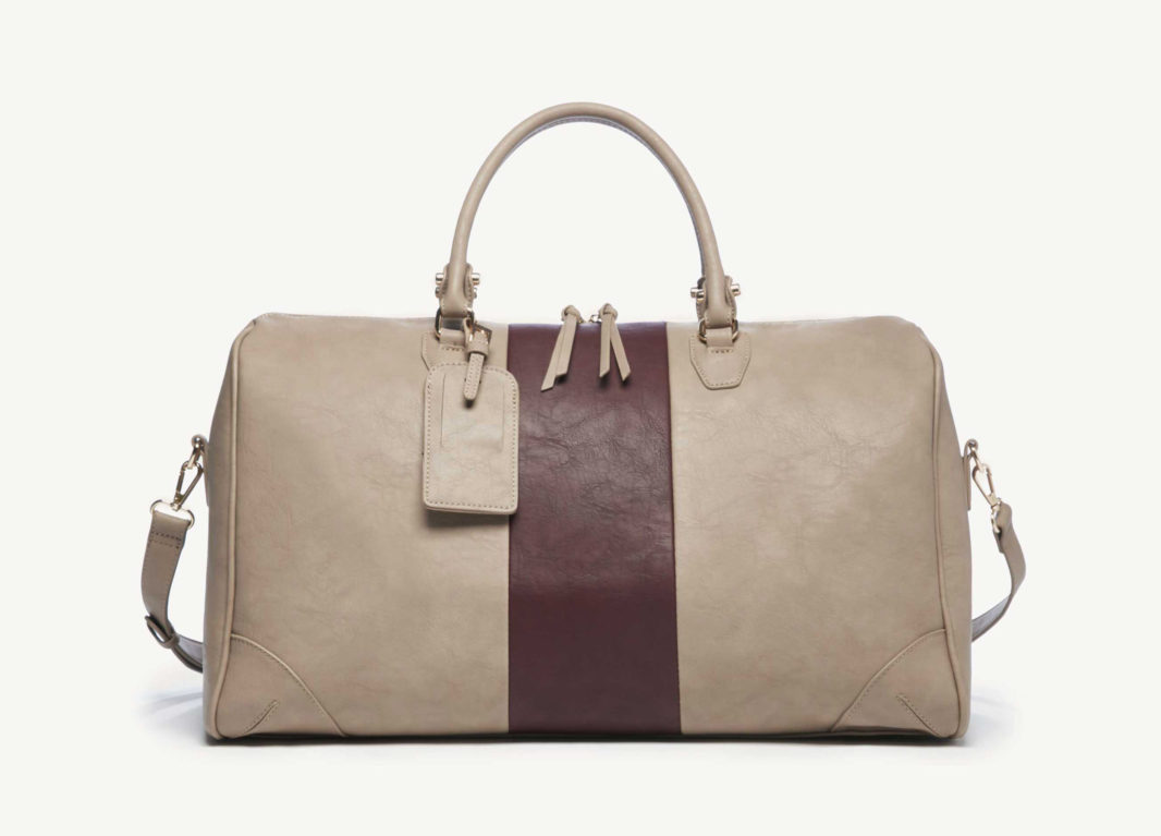 Sole Society taupe vegan leather duffle weekender with colorblock burgundy stripe down the middle. Top handles and shoulder strap.