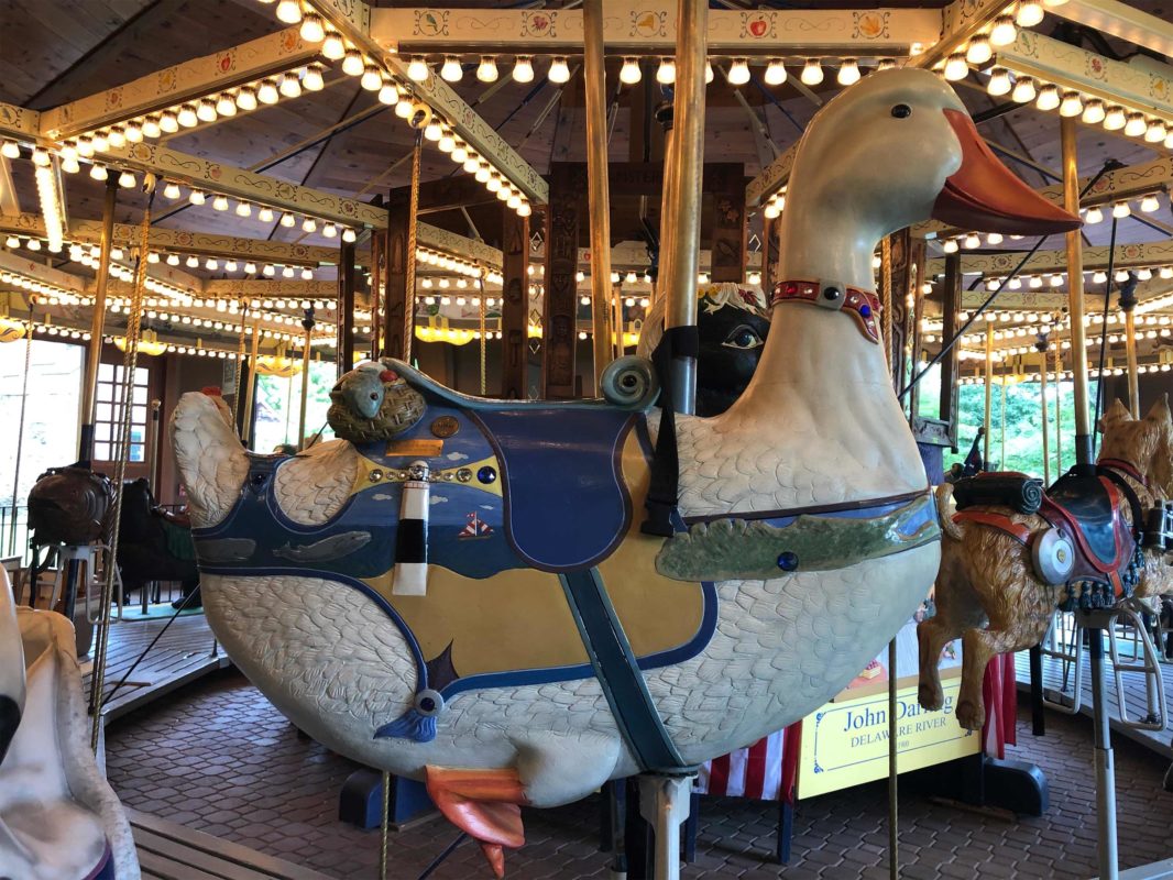 The charming Empire State Carousel with unique hand-carved animals at Farmers' Museum in Cooperstown